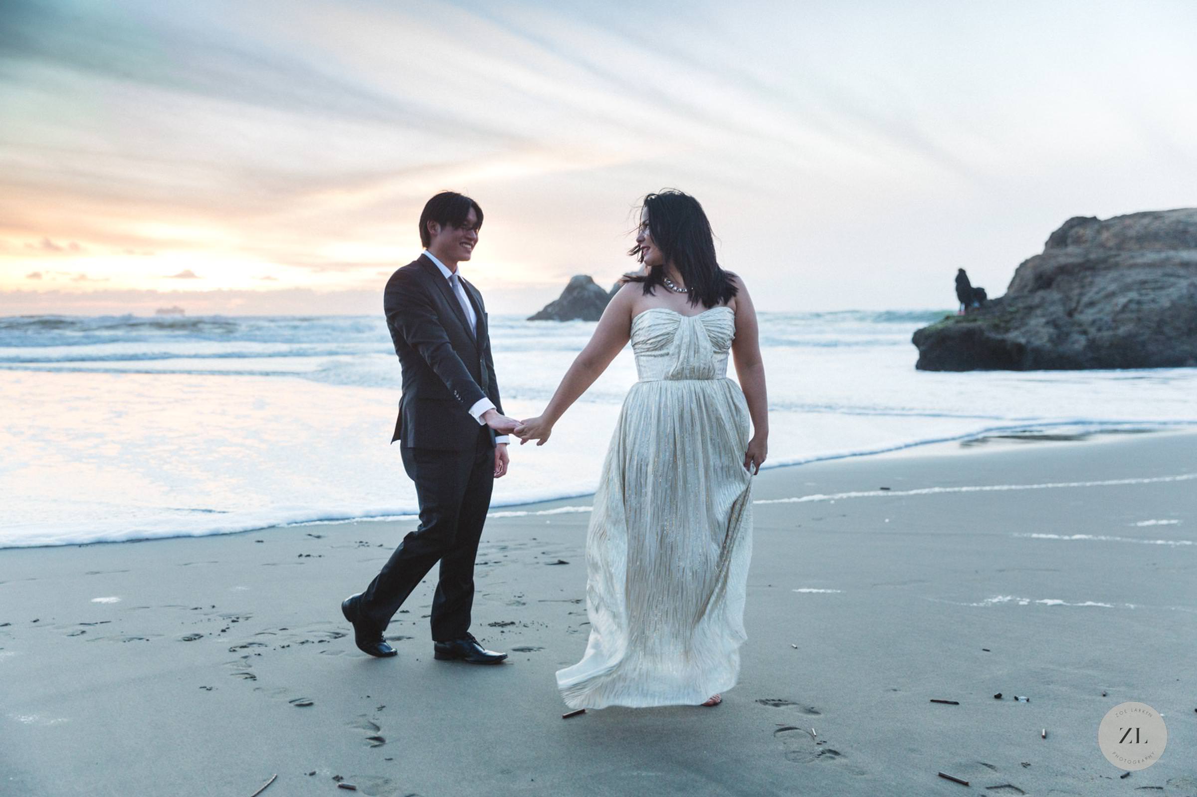 engaged couple on lands end beach with elegant formal clothing