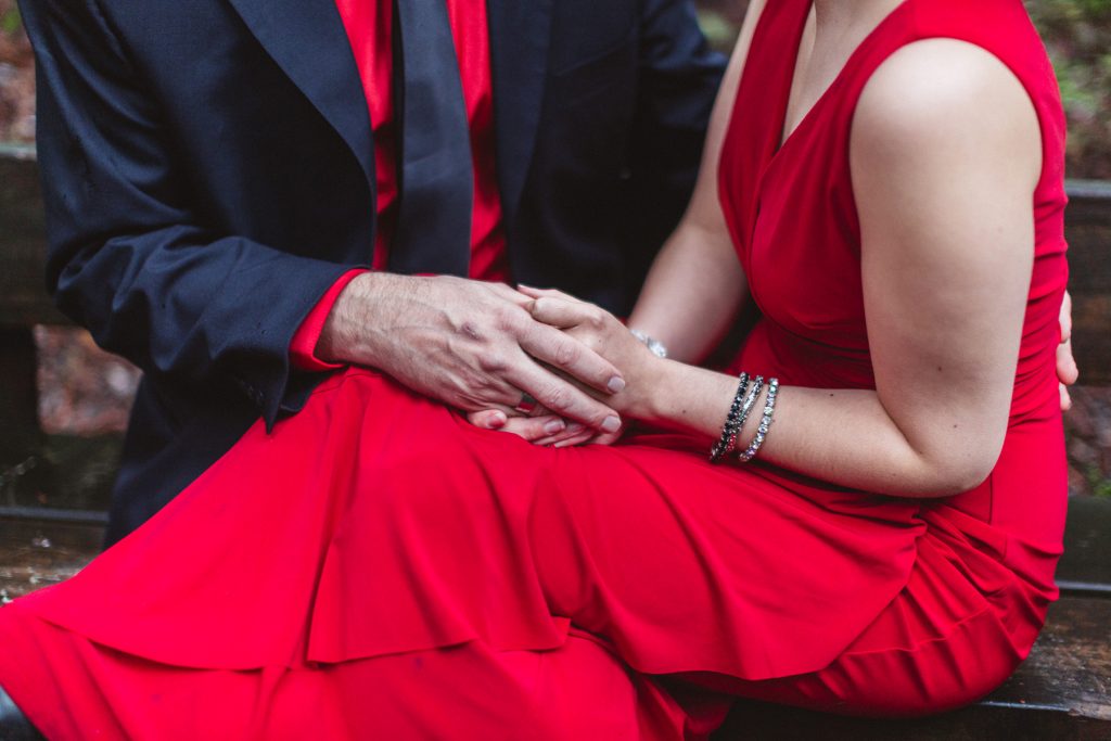 coordinating red and black outfits for oakland engagement shoot