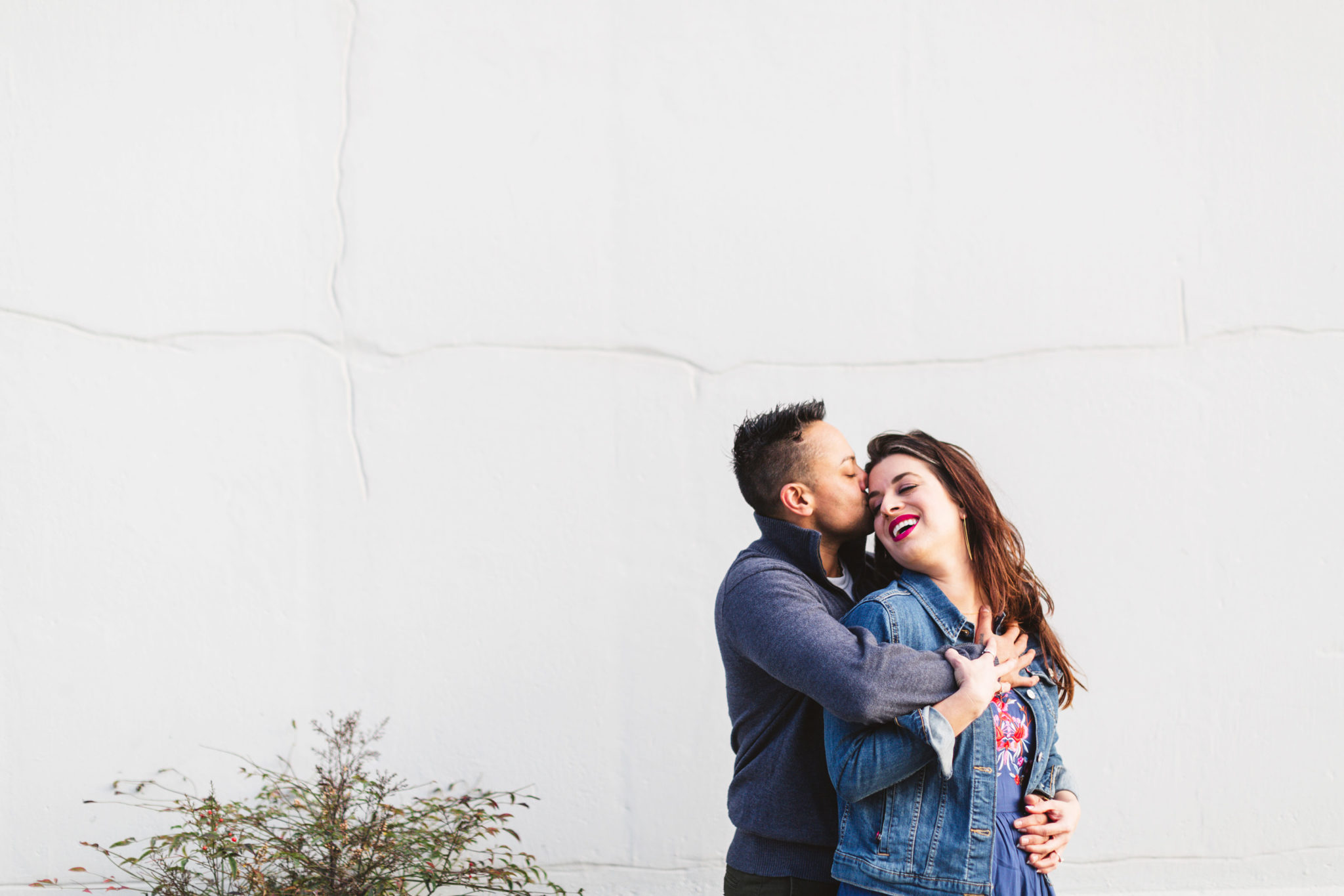 couple posing against a blank wall on their bay area engagement sho| the process of preparing for your engagement shoot with Zoe Larkin Photography