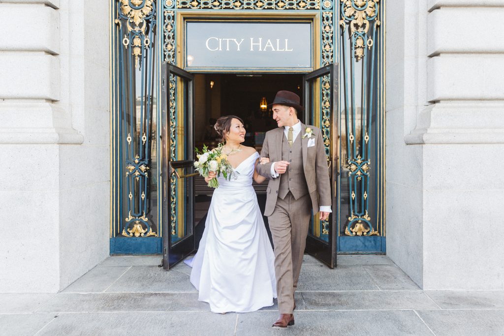 just married couple walking out of san Francisco city hall