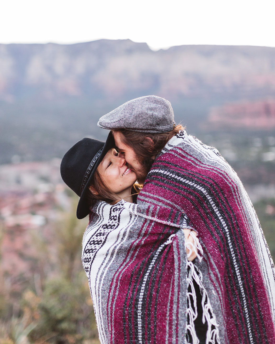 couple under blanket at winter sunrise shoot in sedona near airport