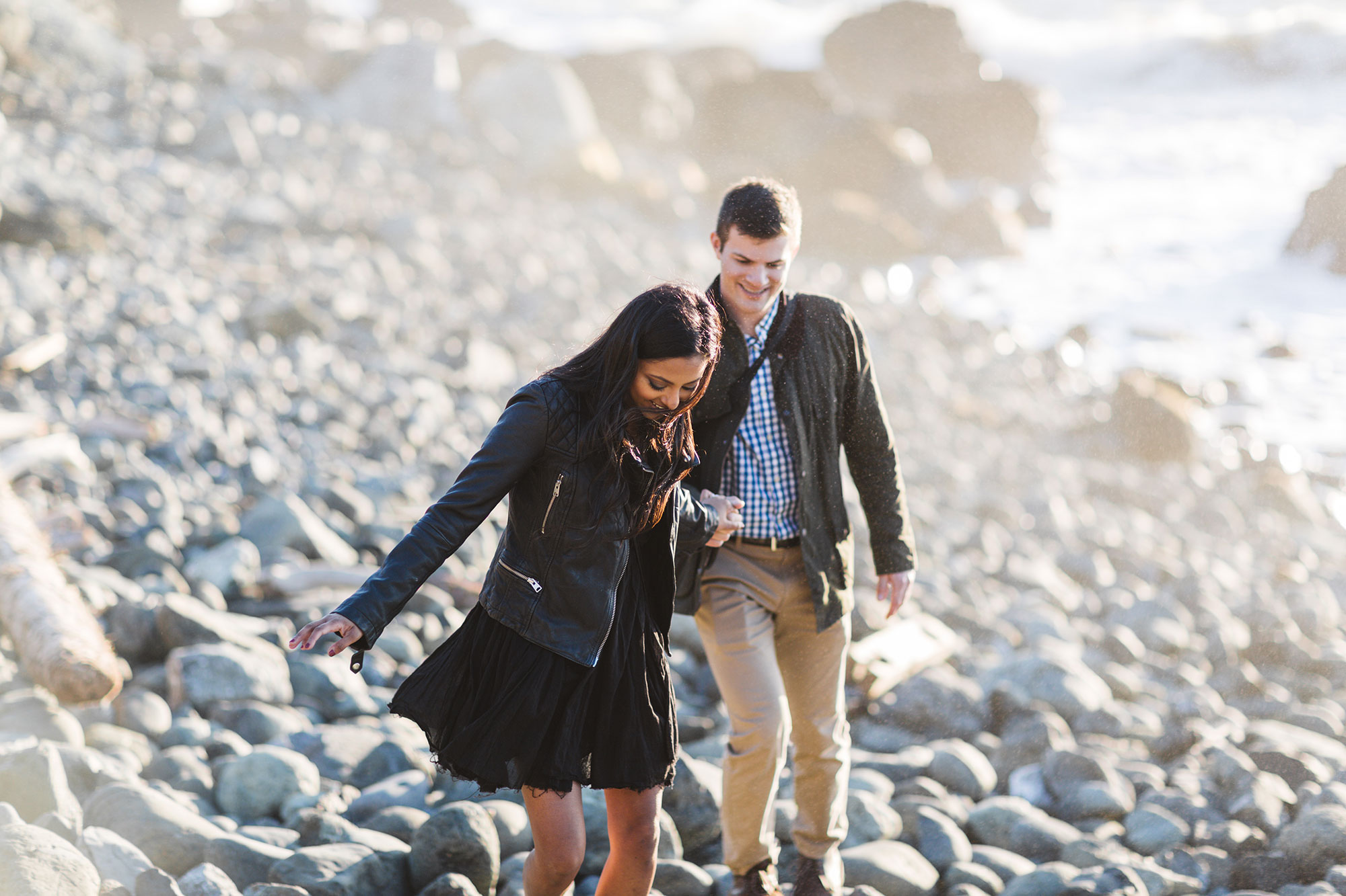 couple on rocky rugged san francisco beach during engagement session