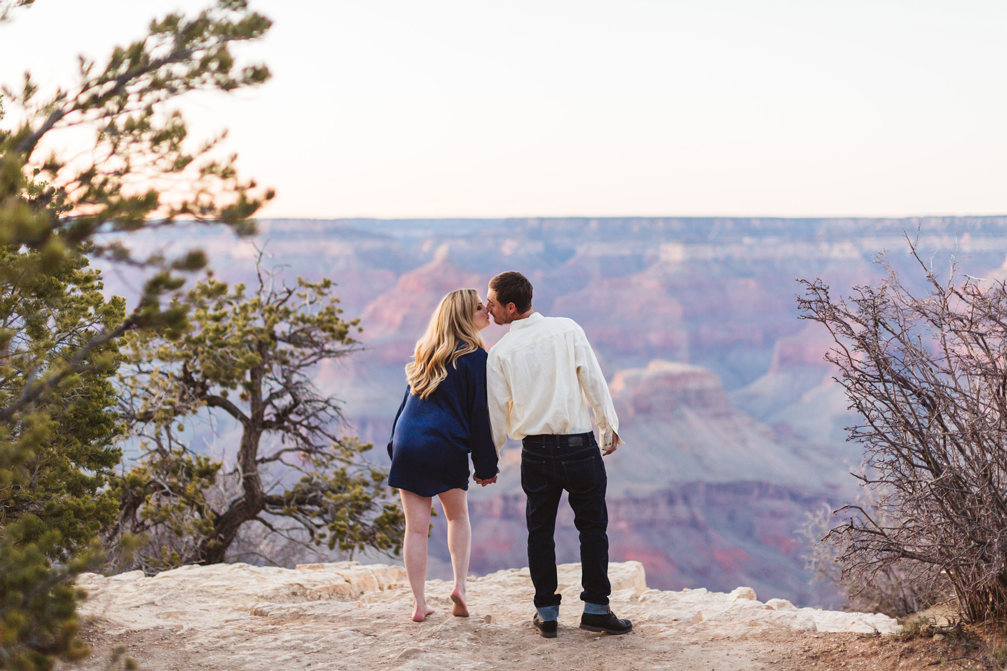 couple kissing over the grand canyon