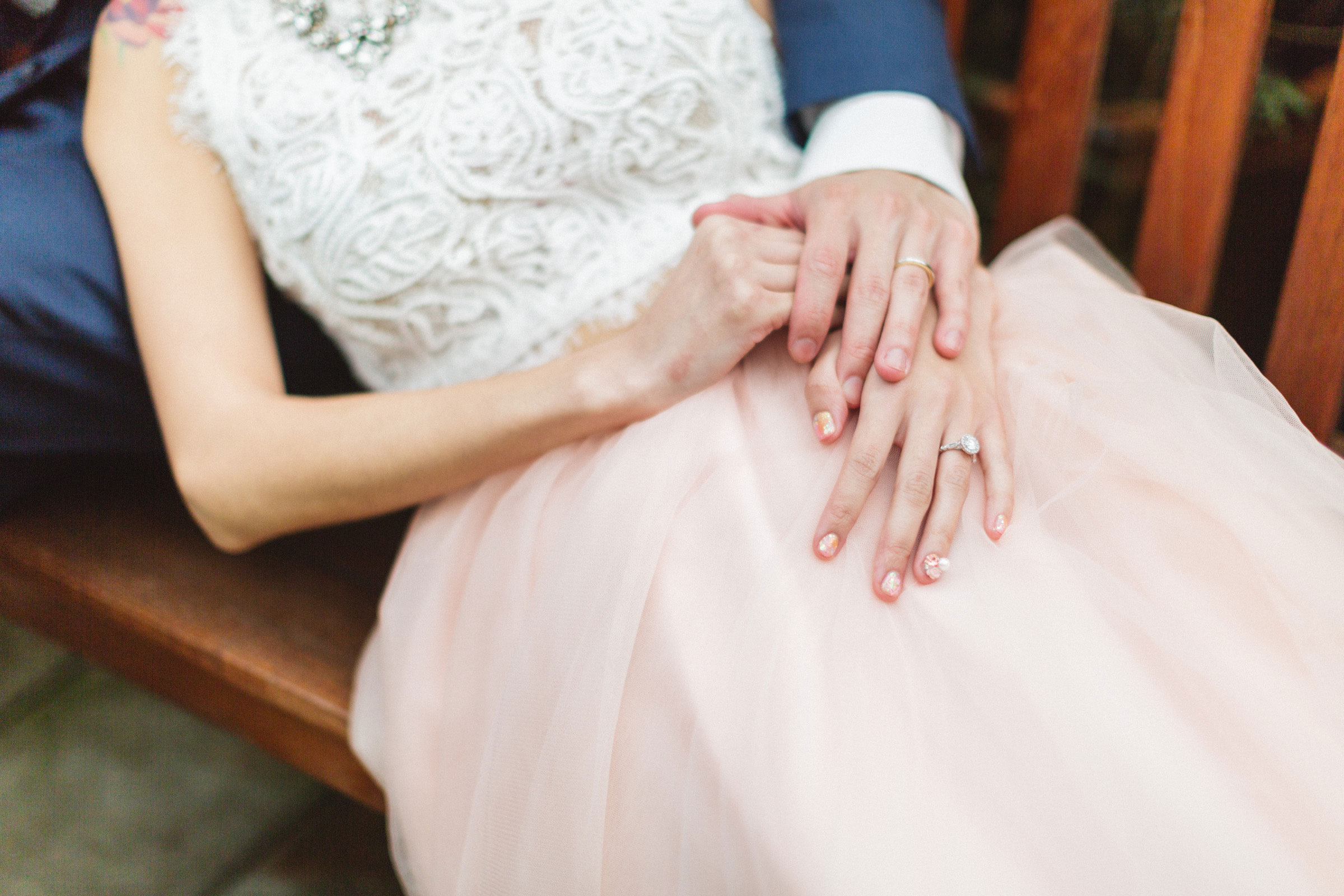 hands on beautiful pink tulle wedding gown