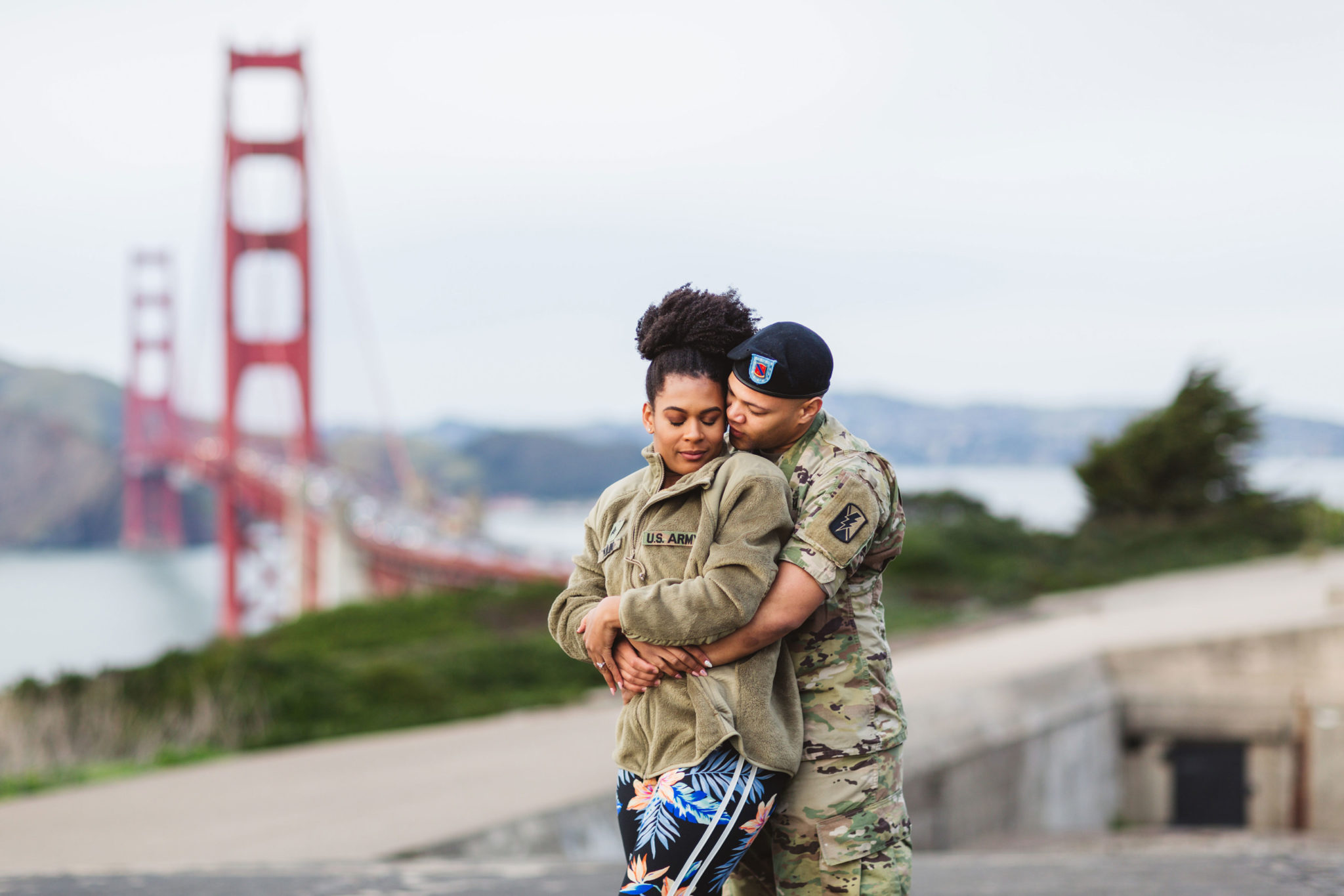 windswept golden gate bridge engagement photos with a military themed couple who love to dance!