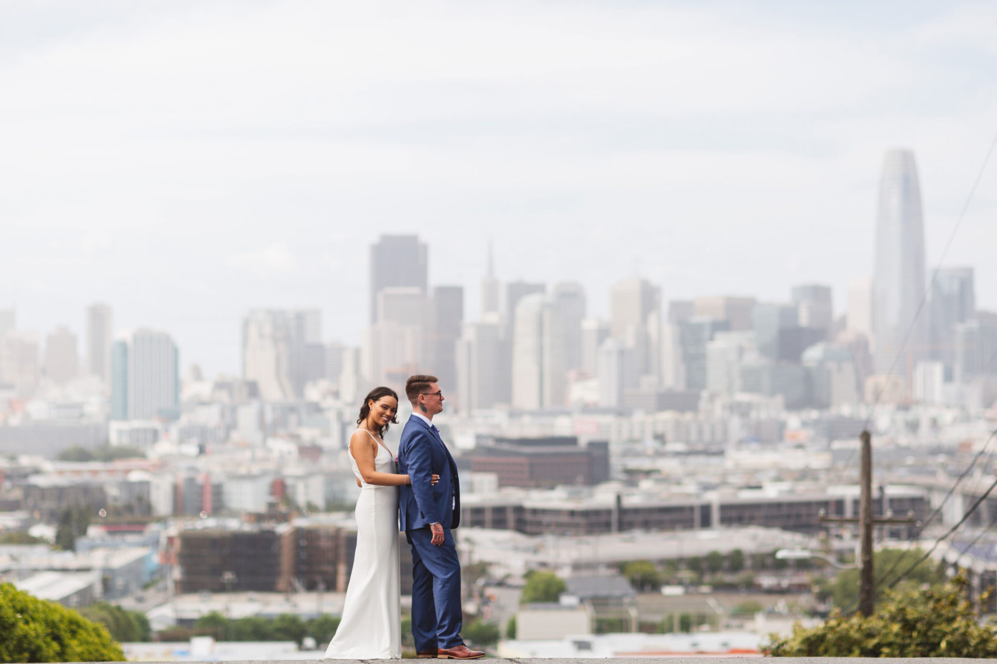 Bride and groom posing with san francisco skyline at Potrero Hill Wisconsin & 20th Streets after city hall wedding