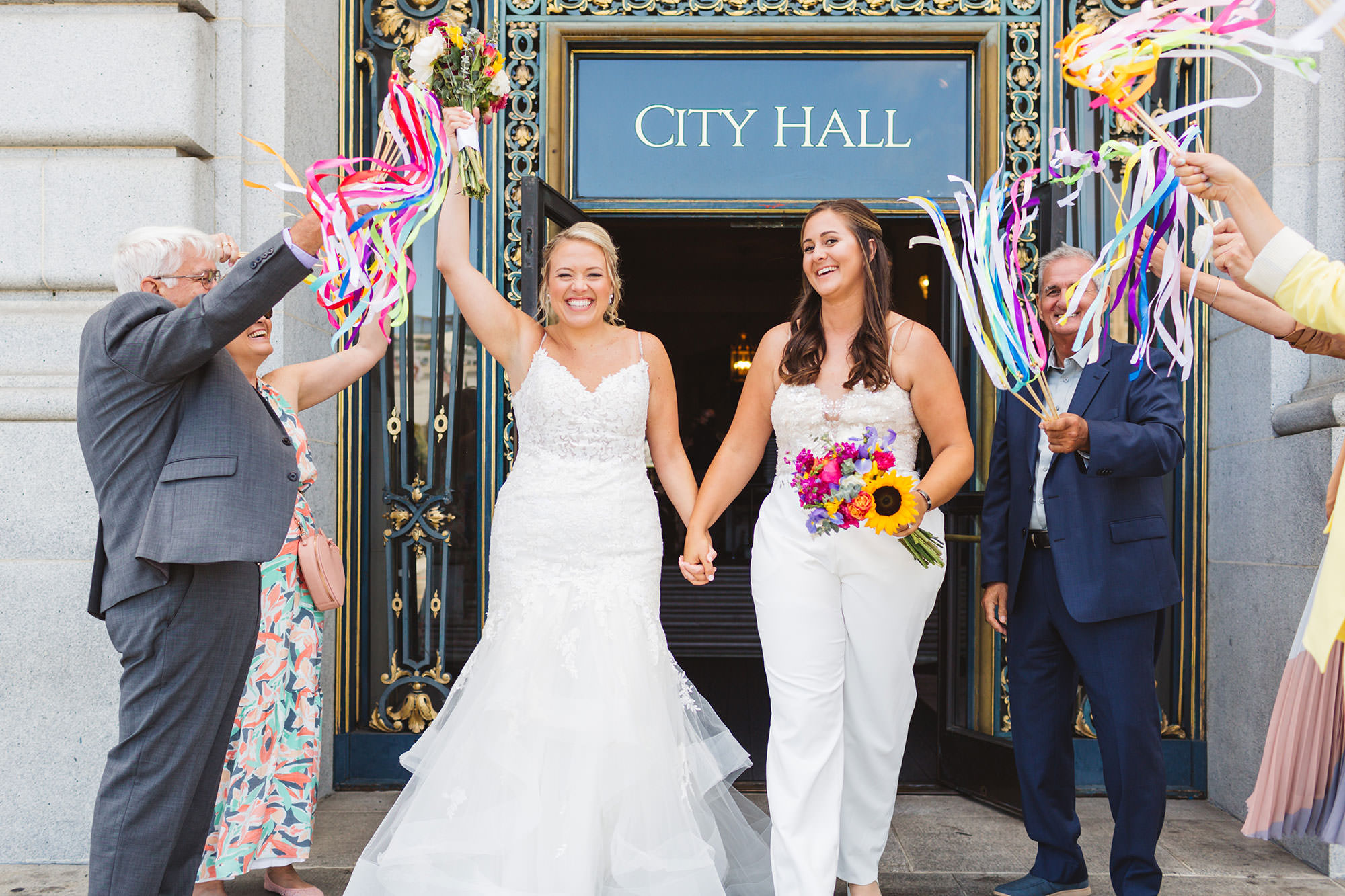 couple exiting san francisco city hall after wedding